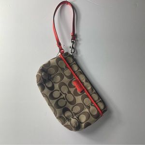Tan coach purse with orange handle and interior